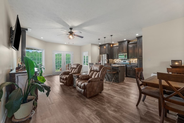living area with recessed lighting, ceiling fan, and dark wood finished floors