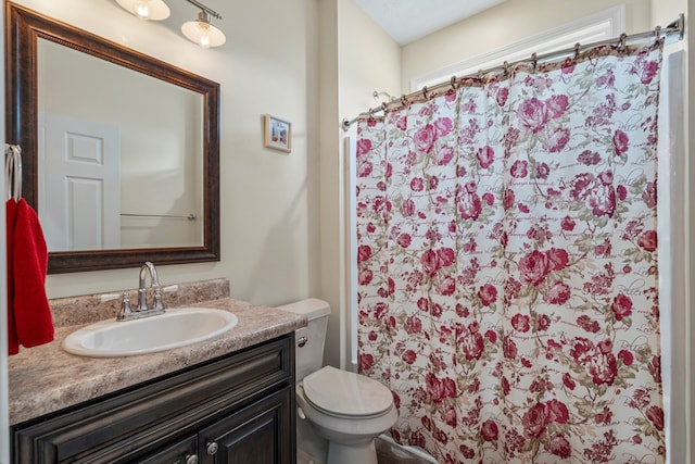 full bathroom with vanity, toilet, and curtained shower