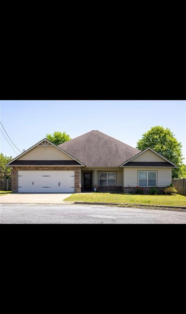 single story home with a front lawn and a garage