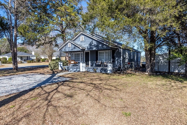 view of front of property with covered porch and a front lawn