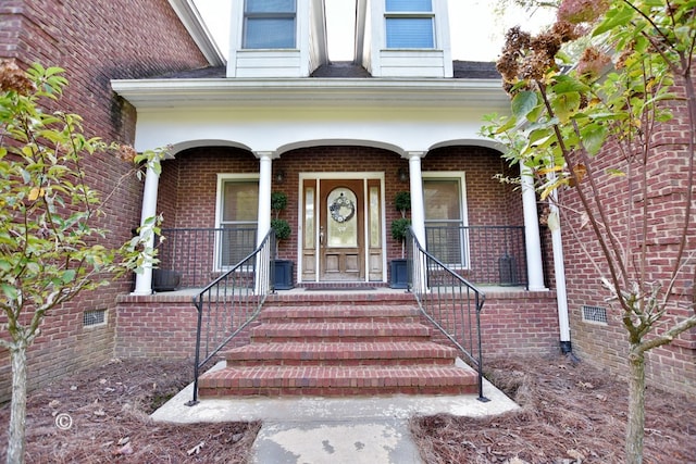 view of exterior entry featuring a porch