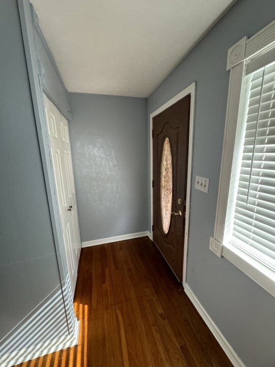 doorway to outside with dark hardwood / wood-style floors