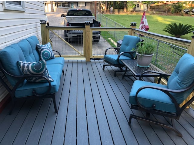 deck featuring a lawn and grilling area