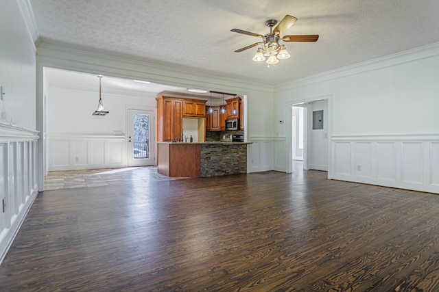 unfurnished living room featuring dark wood finished floors, a textured ceiling, ornamental molding, and electric panel