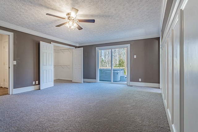 unfurnished bedroom with access to exterior, baseboards, ornamental molding, and carpet flooring