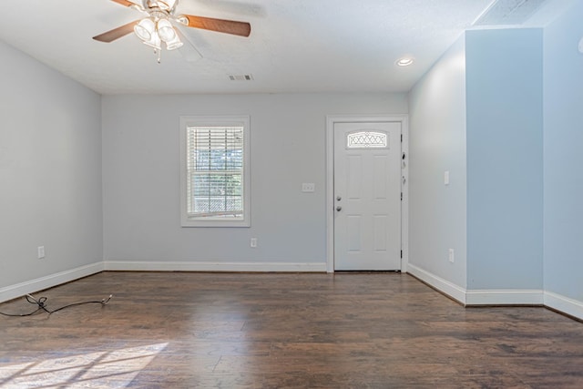 foyer entrance with ceiling fan, baseboards, visible vents, and dark wood finished floors