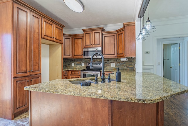 kitchen featuring crown molding, brown cabinets, decorative light fixtures, stainless steel appliances, and a peninsula