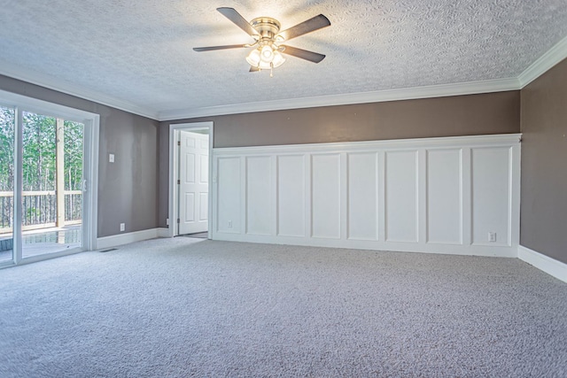 spare room featuring light colored carpet, a decorative wall, and ornamental molding