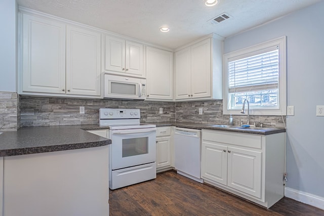 kitchen with a sink, visible vents, white cabinets, and white appliances