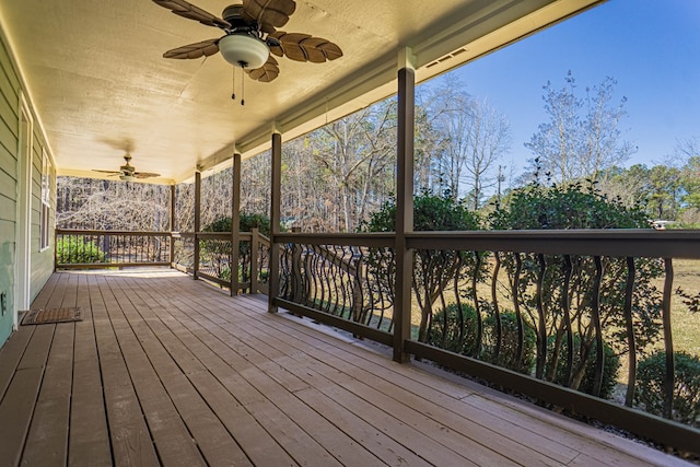 wooden terrace featuring ceiling fan