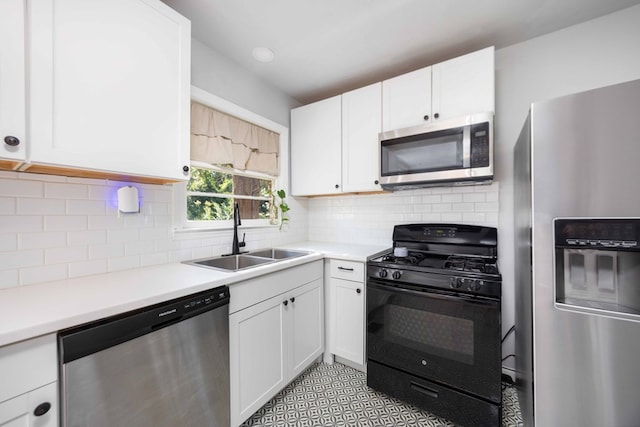 956 Lake Rushin Dr, Columbus, GA 31907 - kitchen featuring stainless steel appliances, white cabinets, light countertops, and tasteful backsplash