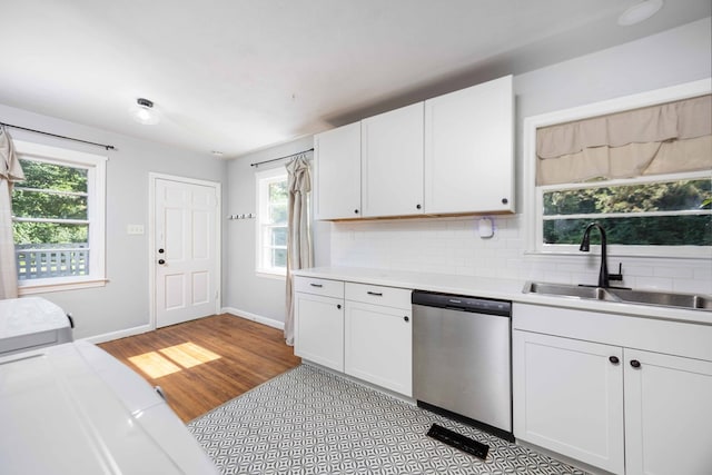 956 Lake Rushin Dr, Columbus, GA 31907 - kitchen featuring stainless steel dishwasher, light countertops, decorative backsplash, and white cabinetry