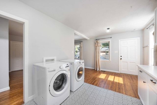 956 Lake Rushin Dr, Columbus, GA 31907 - laundry room featuring washer and clothes dryer, light wood-style floors, and cabinet space