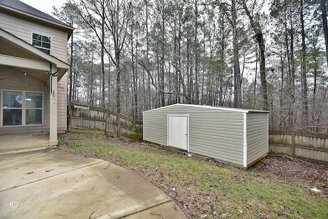 view of yard featuring a patio area and a storage shed