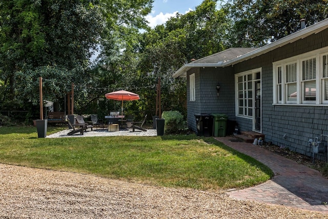 view of yard with entry steps and a patio