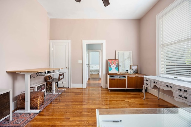misc room with ceiling fan, light wood finished floors, and a wealth of natural light