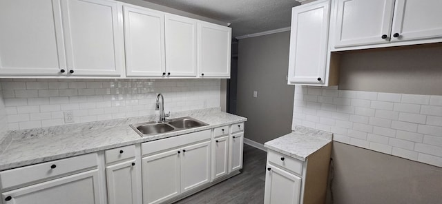 3315 Urban Ave, Columbus, GA 31907 - kitchen with a textured ceiling, dark wood-style flooring, white cabinets, light stone counters, and decorative backsplash