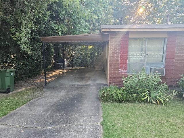 view of parking with a carport, cooling unit, and a lawn