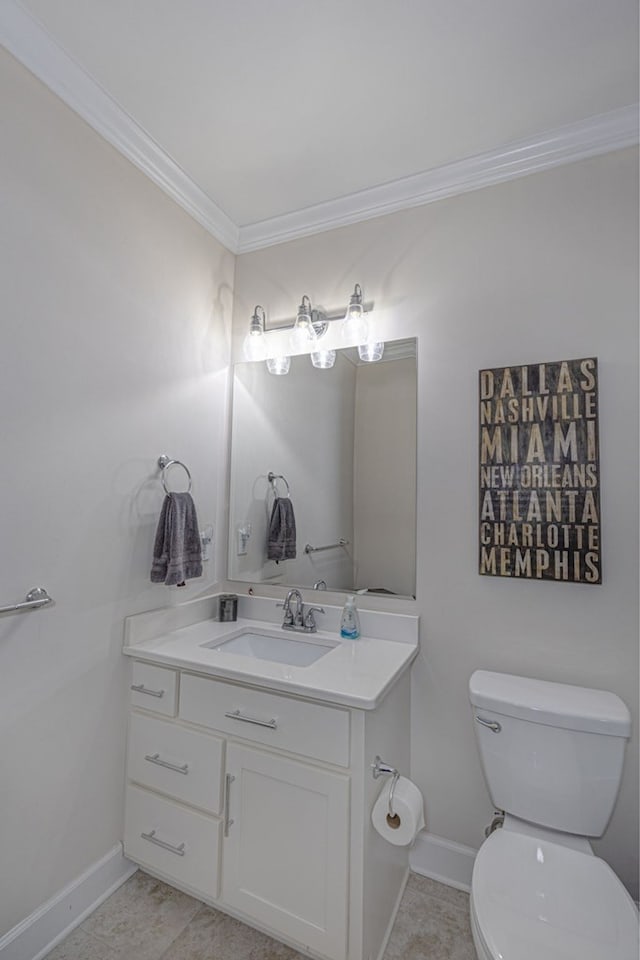 bathroom featuring tile patterned flooring, vanity, toilet, and ornamental molding