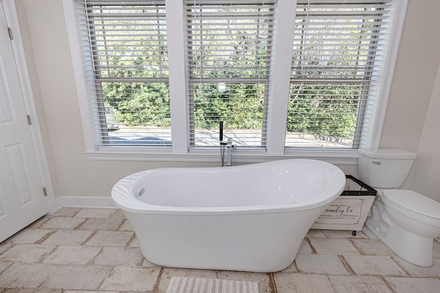 bathroom with toilet and a bathtub