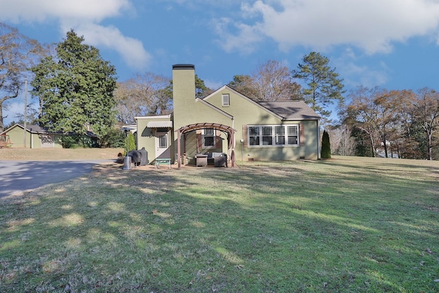 back of house with a lawn