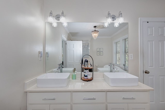 bathroom featuring vanity, an inviting chandelier, and ornamental molding