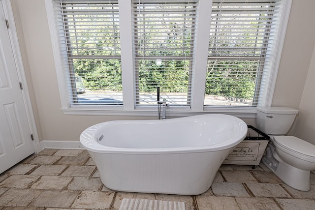 bathroom featuring toilet and a bathing tub