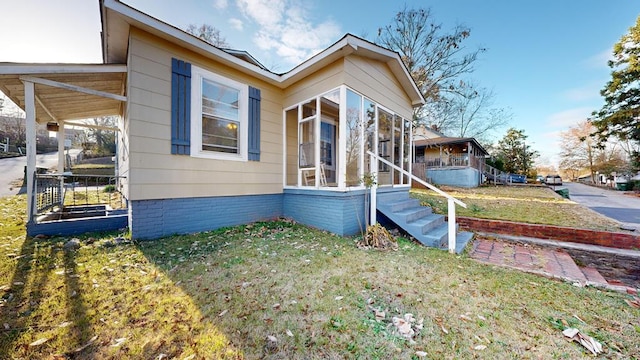 view of front of property with a front lawn and a sunroom