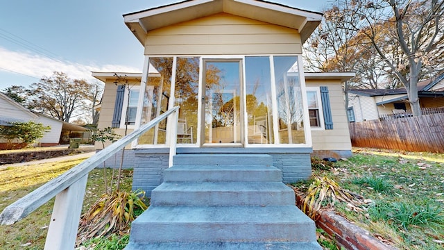 view of front of home featuring a sunroom