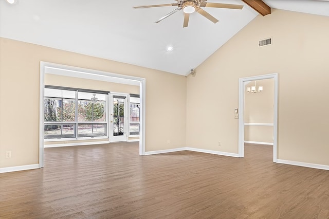 unfurnished room featuring ceiling fan with notable chandelier, wood finished floors, visible vents, baseboards, and beamed ceiling