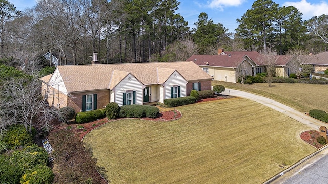 single story home with a front yard and brick siding