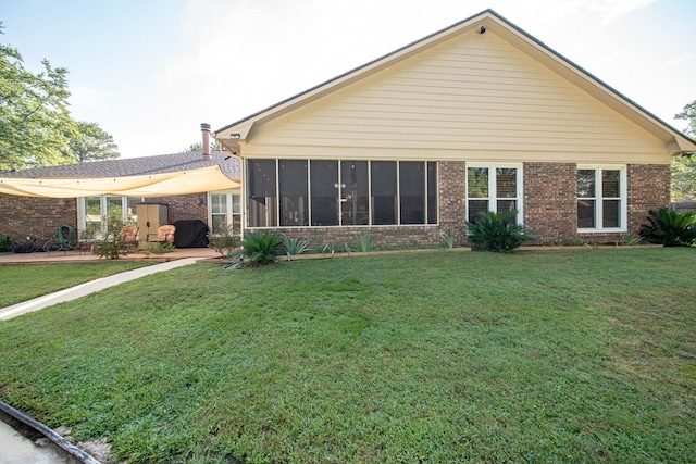 5 Mallard Ct, Midland, GA 31820 - back of house with brick siding, a lawn, and a sunroom