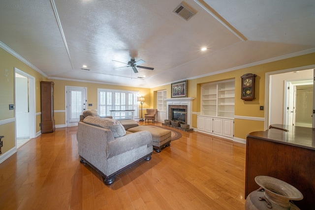 5 Mallard Ct, Midland, GA 31820 - living room featuring a ceiling fan, light wood-style flooring, built in features, a glass covered fireplace, and ornamental molding
