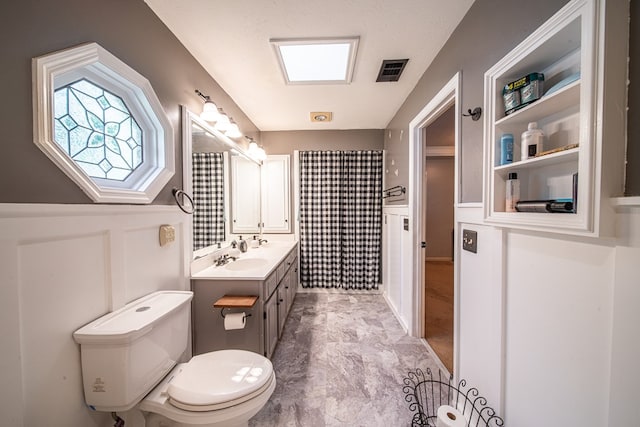 5 Mallard Ct, Midland, GA 31820 - full bathroom with vanity, curtained shower, wainscoting, and a decorative wall