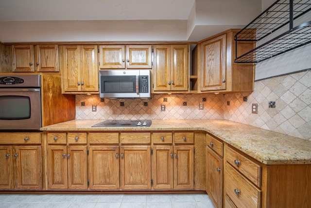 5 Mallard Ct, Midland, GA 31820 - kitchen featuring appliances with stainless steel finishes, light stone counters, tasteful backsplash, brown cabinetry, and light tile patterned floors