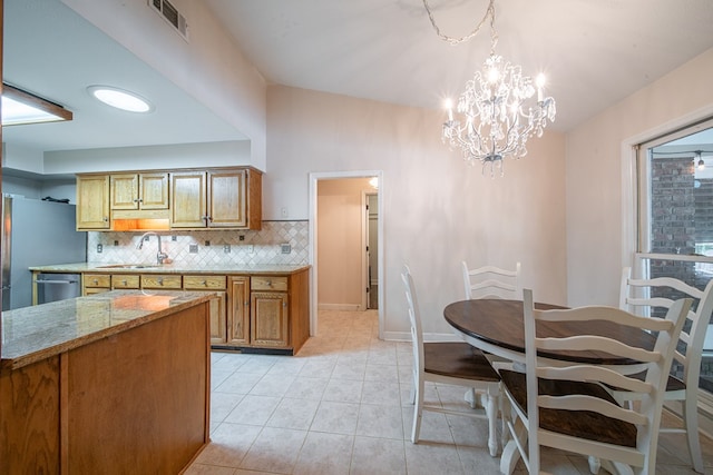 5 Mallard Ct, Midland, GA 31820 - kitchen with backsplash, brown cabinetry, light tile patterned floors, a chandelier, and dishwasher