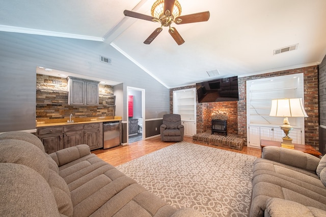 5 Mallard Ct, Midland, GA 31820 - living room featuring a wood stove, ceiling fan, and light wood finished floors