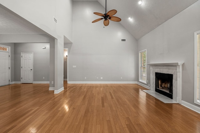 240 Lee Road 2099, Phenix City, AL 36870 - unfurnished living room with a ceiling fan, high vaulted ceiling, light wood-style flooring, a high end fireplace, and baseboards