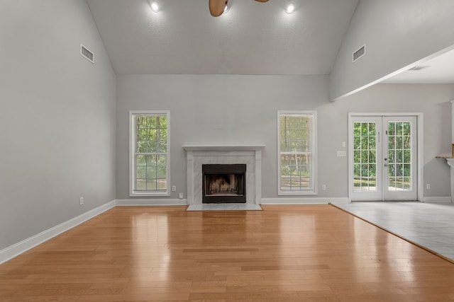 240 Lee Road 2099, Phenix City, AL 36870 - unfurnished living room featuring high vaulted ceiling, a fireplace, light wood-style floors, baseboards, and plenty of natural light