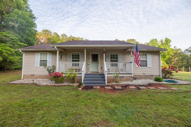 ranch-style home featuring covered porch, crawl space, and a front lawn