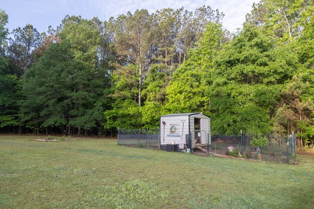 view of yard with an outdoor structure, exterior structure, and fence