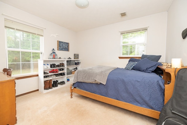 carpeted bedroom with baseboards and visible vents