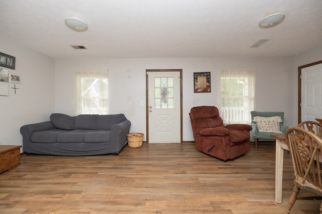 living area featuring visible vents and light wood finished floors