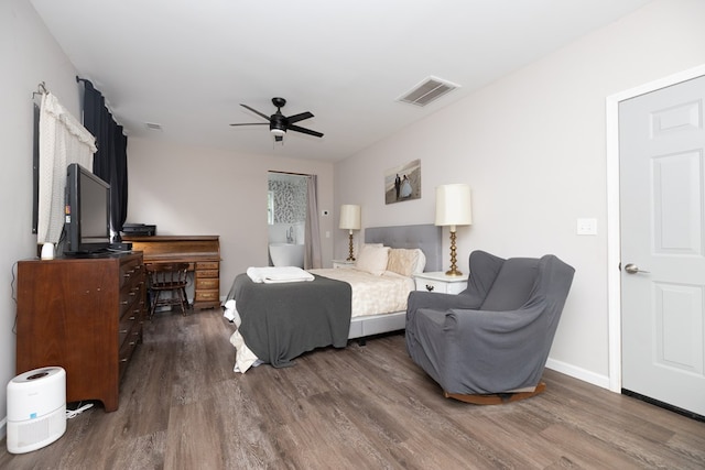 bedroom featuring baseboards, visible vents, wood finished floors, and ceiling fan