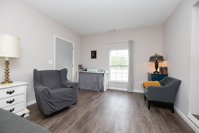 living area featuring dark wood-style flooring, baseboards, and visible vents
