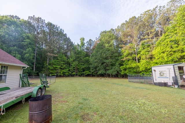 view of yard featuring fence and a deck