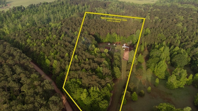 birds eye view of property featuring a wooded view