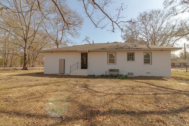 back of house featuring crawl space, a lawn, and brick siding