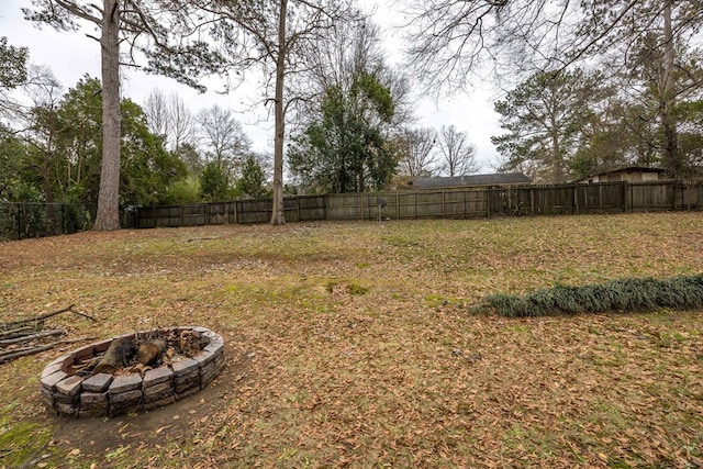 view of yard with an outdoor fire pit