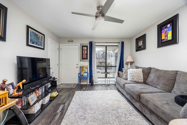 living room featuring ceiling fan and dark hardwood / wood-style floors